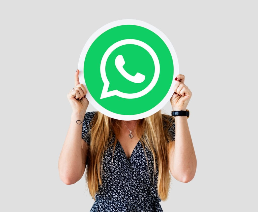 woman showing whatsapp messenger icon